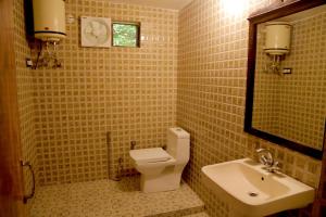 a bathroom with a white toilet and a sink at Hotel Green Heaven Resort in Pushkar