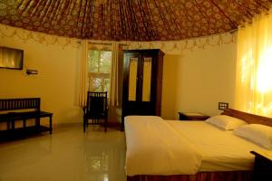 A bed or beds in a room at Hotel Green Heaven Resort