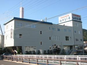 a building with a sign on top of it at Business Hotel Miharashitei in Kumano