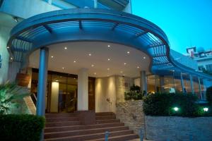 a building with a blue entrance with stairs in front at Cleopatra Hotel in Nicosia