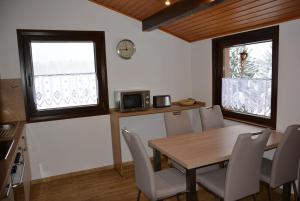 a dining room with a wooden table and chairs at Ferienhaus Starenweg 8 in Tennenbronn