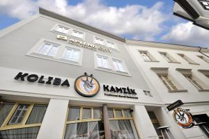 a white building with a clock on the front of it at APLEND CITY Hotel Perugia in Bratislava