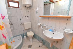 a small bathroom with a sink and a toilet at Roberto 3 in Veli Lošinj