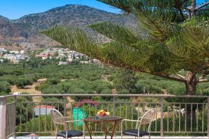 a table and chairs with a view of a mountain at Nontas Apartments in Hersonissos