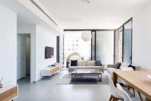 a living room with a couch and a table at Modern 2-BR in Carmel Market by HolyGuest in Tel Aviv