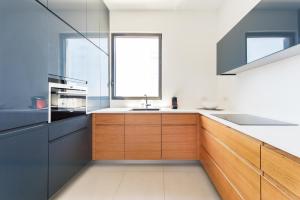 a kitchen with a sink and a window at Modern 2-BR in Carmel Market by HolyGuest in Tel Aviv