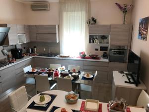 a kitchen with two tables and chairs and a kitchen with at Civico7 in Villa San Giovanni