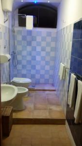 a bathroom with a white toilet and a sink at B&B La Dimora Di Nettuno in Naples