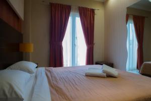 a bedroom with a bed with two towels on it at Lidra Hotel in Aridaia