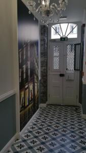 a hallway with a white door and a tile floor at Edificio Charles 204 in Funchal