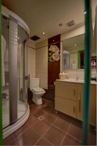 a bathroom with a toilet and a shower and a sink at Lidra Hotel in Aridaia