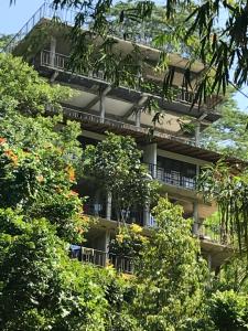 an apartment building with trees in front of it at Tikiri Latha Hanthana in Kandy