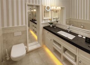 a bathroom with a toilet and a sink and a shower at Europa Hotel Kühlungsborn in Kühlungsborn +106 photos
