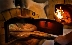 a bread is coming out of a brick oven at Apartmany Izbica in Červený Kláštor