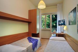Postel nebo postele na pokoji v ubytování Hotel Capri