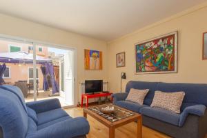 a living room with two blue couches and a table at Brisas in Palma de Mallorca