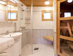 a bathroom with a shower and a sink at Holiday Club Ähtäri Cottages in Ähtäri +28 photos