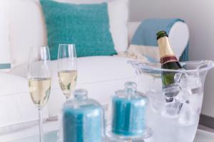 a table with two glasses and a bottle of wine at Gr Suites Boutique Alcazaba in Málaga