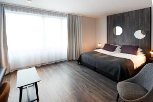 Ένα ή περισσότερα κρεβάτια σε δωμάτιο στο Fosshotel Husavik