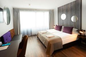 Postel nebo postele na pokoji v ubytování Fosshotel Husavik + 37 fotografií
