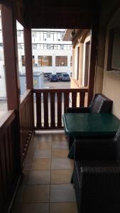 a balcony with chairs and a table and a view of a street at Vila Montana in Constanţa