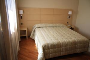 Postel nebo postele na pokoji v ubytování Hotel Ottagono