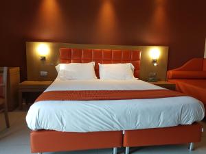a bedroom with a large bed with an orange headboard at Hotel Ristorante La Campagnola in Cassino