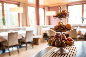 a three tiered display of fruit on a table at Hotel Das Zentrum in Sölden