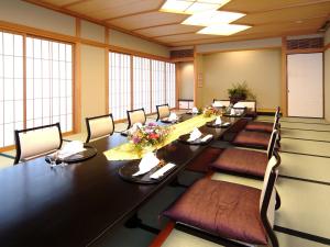 a large conference room with a long table and chairs at Ibusuki Iwasaki Hotel in Ibusuki