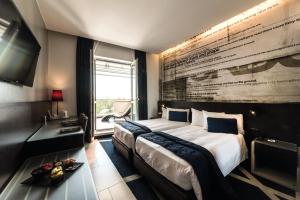 Ліжко або ліжка в номері Hotel Manin +37 фото