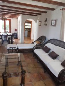 a living room with couches and a table at Moraira Amazing Rustic Village in Moraira