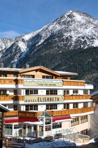 a hotel in front of a snow covered mountain at Hotel Elisabeth Superior Sölden in Sölden