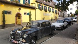 two old cars parked on the side of a street at Achkarrer Krone in Achkarren