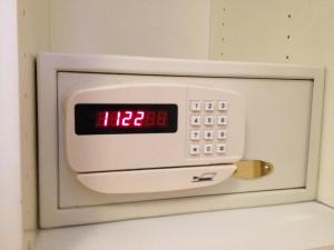 an alarm clock on the door of a refrigerator at Amadeus Hotel in Haarlem