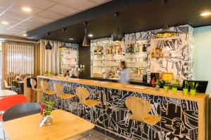 a bar with a black and white patterned wall at ibis De Haan in De Haan