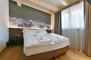 Posteľ alebo postele v izbe v ubytovaní Dolomeet Boutique Hotel