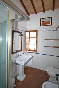 a bathroom with a sink and a toilet at Villa Castiglione by PosarelliVillas in Contignano