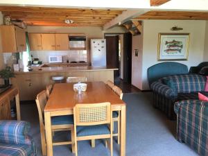 a kitchen and living room with a table and a couch at Marigold's 37 Critchley Common in Dullstroom