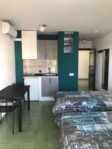 a kitchen with a bed and a table in a room at Coconut Apartments - Adults Only in Magaluf