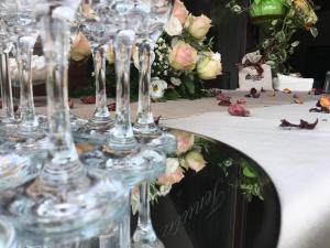 a group of wine glasses on a table with flowers at Tenuta Ferrara in Altavilla Silentina
