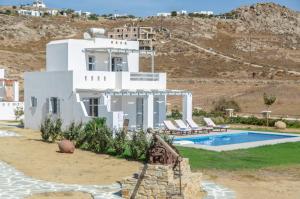 a villa with a swimming pool and a house at Natura Villas in Naxos in Mikri Vigla