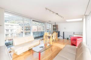 a living room with white furniture and a large window at Apartment O'Hara in Zell am See