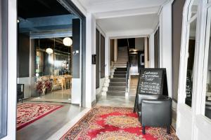 a hallway of a building with a red rug at Fira Apartments by gaiarooms in Barcelona