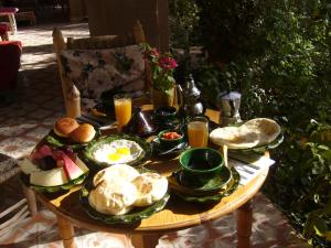- une table avec des assiettes de nourriture et de boissons dans l'établissement Villa Zagora Ma Villa au Sahara, à Zagora