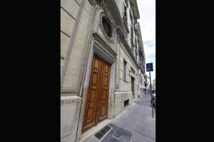 a building with a wooden door on a street at Relais Vatican Secret in Rome