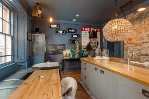 a bar with a dog sitting at a table at The Baxter Hostel in Edinburgh