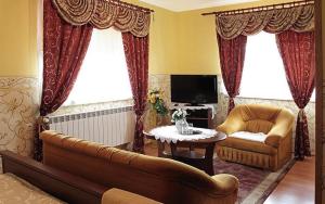 a living room with a couch and a table at Hotel Miły in Krosno