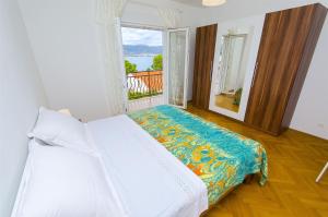 a bedroom with a bed and a large window at House Marija in Trogir +25 photos