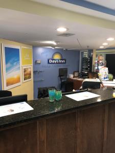 an office with a desk with two glasses on a counter at Days Inn by Wyndham Raleigh-Airport-Research Triangle Park in Morrisville