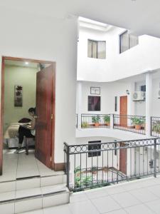 a person sitting in a chair on a balcony in a house at Hotel Palmeras de Elim in Matagalpa